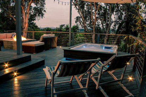 backyard deck with built in spa jacuzzi, custom concrete fire pit, stainless steel cable railing, trex composite decking with steps and outdoor lighting