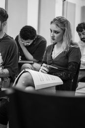 Frances sits with a music score during a ZEST rehearsal for the musical RENT.