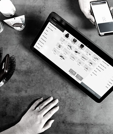 person holding smartphone beside tablet