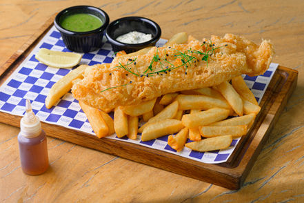Fish and chips on a blue checkered board, food photography for delivery apps UAE
