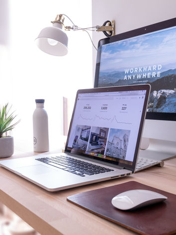 Marketing strategy notebook with laptop and reading glasses on desk for business planning