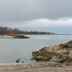 Overcast day overlooking the beach with a lighthouse in the background