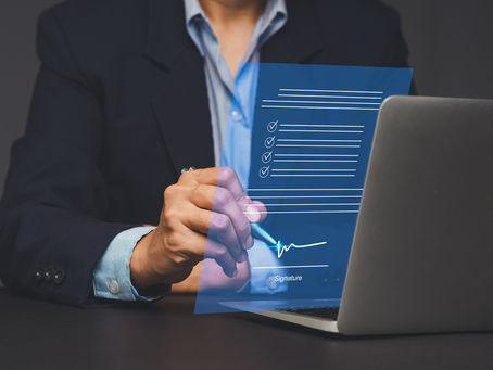 insurance agent signing a digital document on a laptop