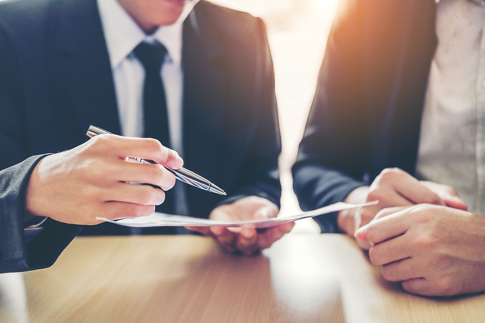 man with a pen and paper explaining something to another man