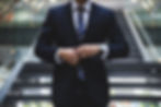 A man adjusting his suit jacket
