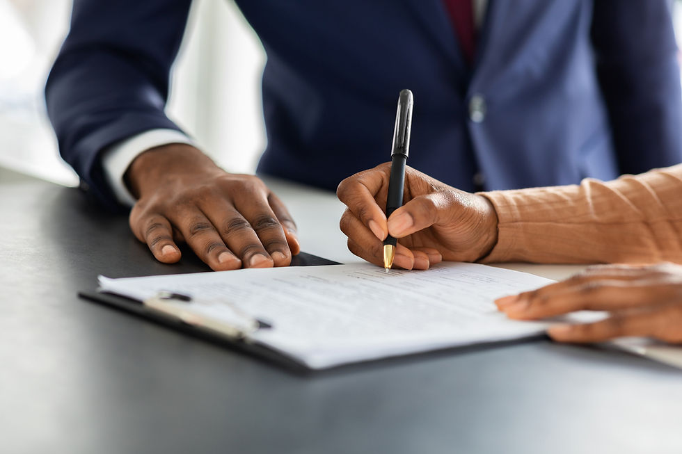 a woman signing some papers on a clipboard with an agent standing next to her
