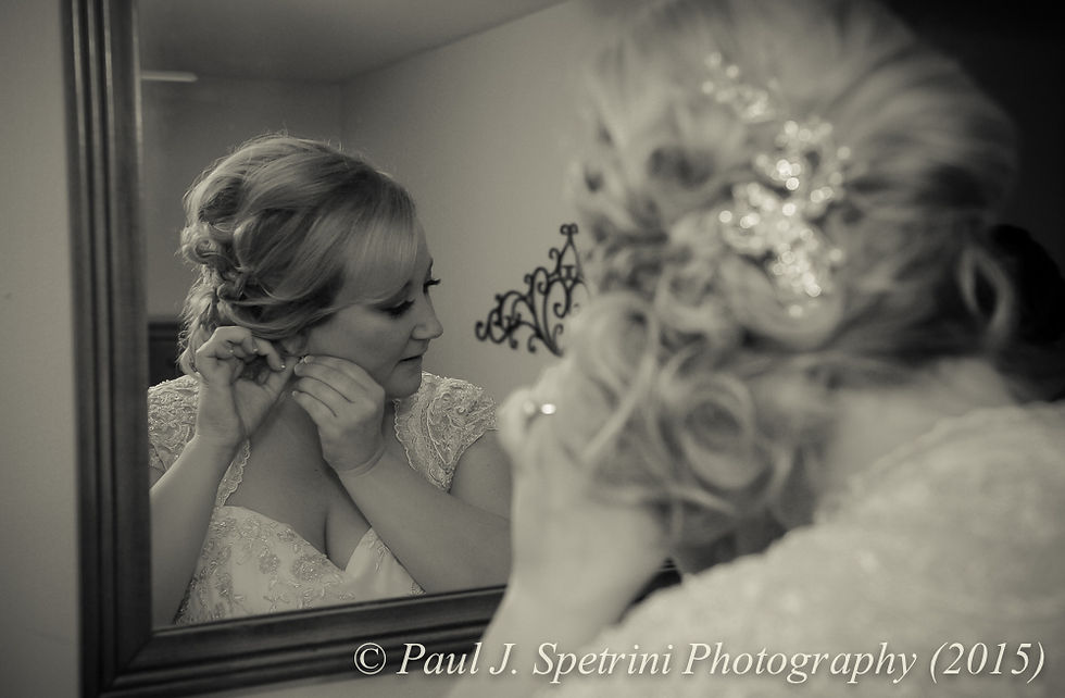 Kerry puts her earrings on prior to her fall wedding at Quidnessett Country Club in North Kingstown, Rhode Island on October 23rd, 2015.