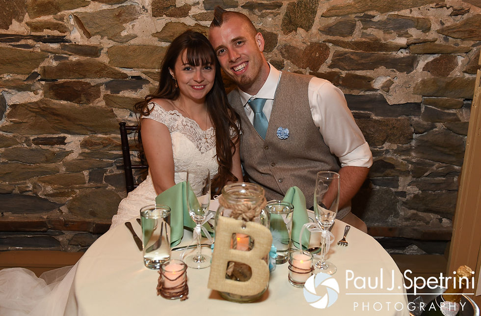 Krystal and Ian pose for a photo at the sweetheart table during their May 2016 wedding reception at DeWolf Tavern in Bristol, Rhode Island.
