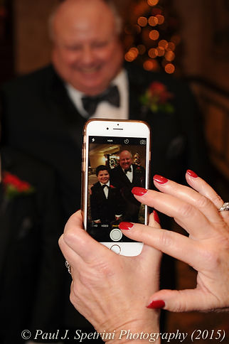 A guest takes a photo during Cathy and Ron's December 2015 wedding at Quidnessett Country Club in North Kingstown, Rhode Island.
