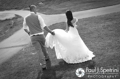 Ian helps Krystal walk in her dress following their May 2016 wedding at Colt State Park in Bristol, Rhode Island.