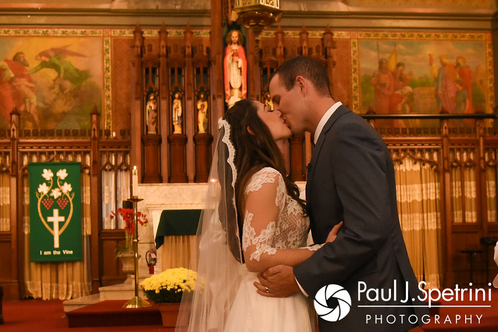 Keiran and Jessica kiss during their October 2017 wedding ceremony at the Assumption of the Blessed Virgin Mary Church in Providence, Rhode Island.
