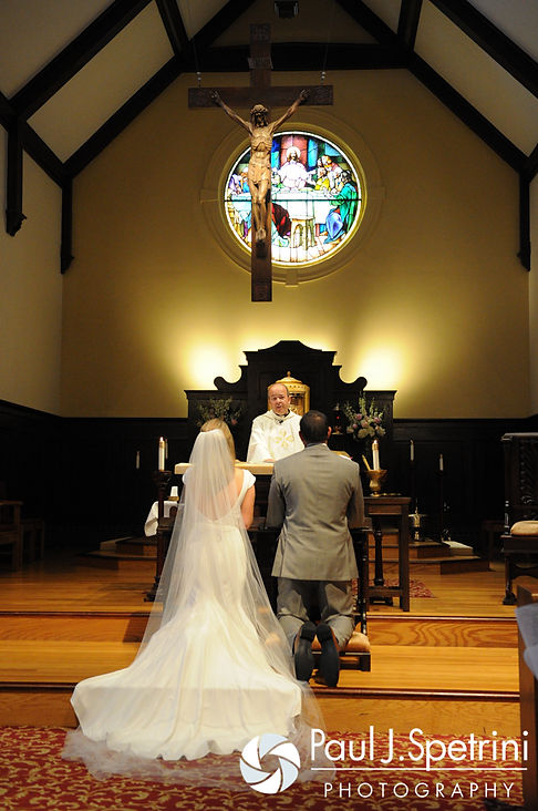 Amy and DJ kneel at the altar during their June 2016 wedding ceremony at St. Thomas More Church in Narragansett, Rhode Island.