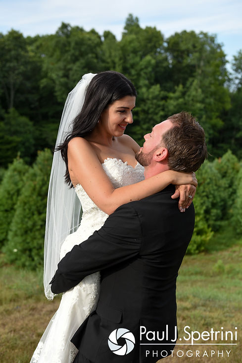 Lauryn and Justin embrace during a formal photo at their July 2016 wedding reception at the Overlook at Geer Tree Farm in Griswold, Connecticut.