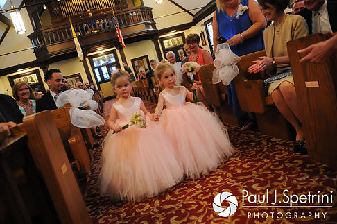 The flower girls come down the aisle during Amy & DJ's June 2016 wedding ceremony at St. Thomas More Church in Narragansett, Rhode Island.