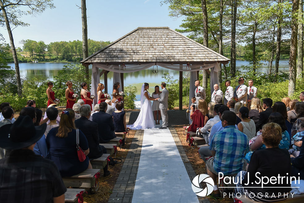 Heather and John hold hands during their July 2016 wedding ceremony at Crystal Lake Golf Club in Burrillville, Rhode Island.