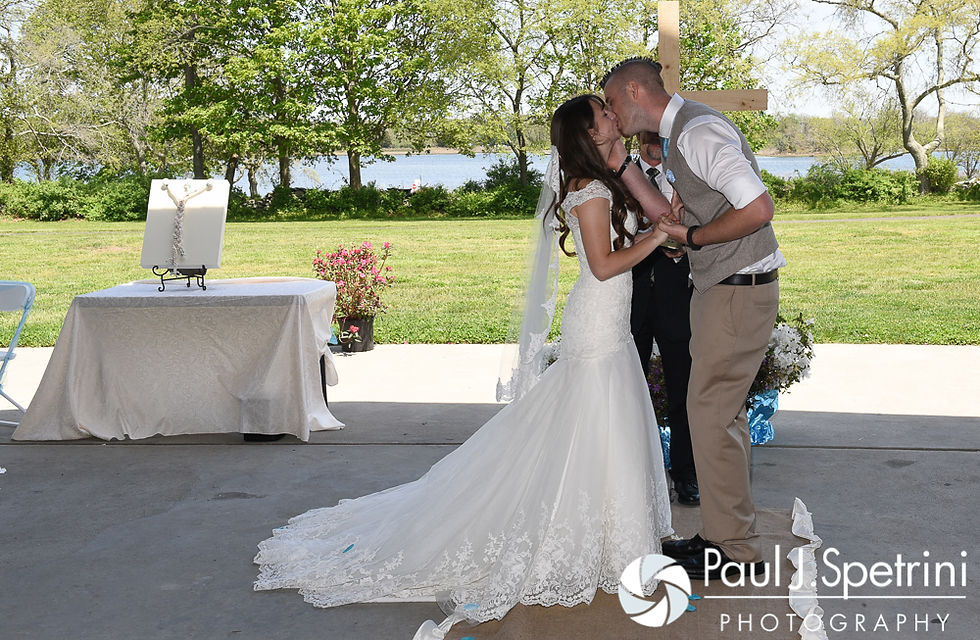 Krystal and Ian share their first kiss during their May 2016 wedding at Colt State Park in Bristol, Rhode Island.
