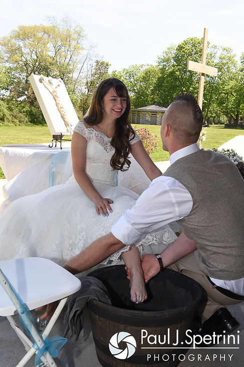 Ian washes Krystal's feet during their May 2016 wedding at Colt State Park in Bristol, Rhode Island.