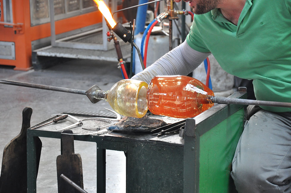 A glassblower joins two glass parts of same wall thickness