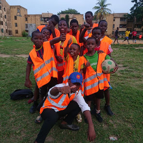 Group of Afidi summer camp children in orange vests in Cameroon, Central Africa