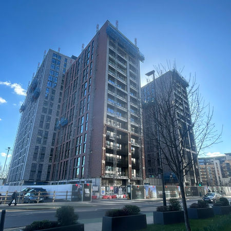 Whitehall Riverside Leeds development and aluminium balustrades against a blue sky during construction