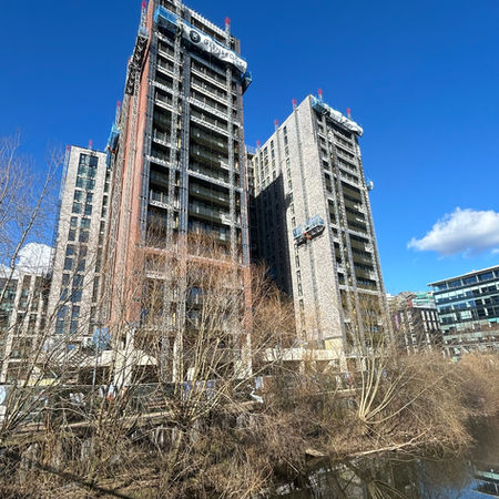 Whitehall Riverside Leeds development and aluminium balustrades against a blue sky during construction