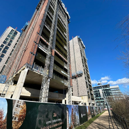 Whitehall Riverside Leeds development and aluminium balustrades against a blue sky during construction