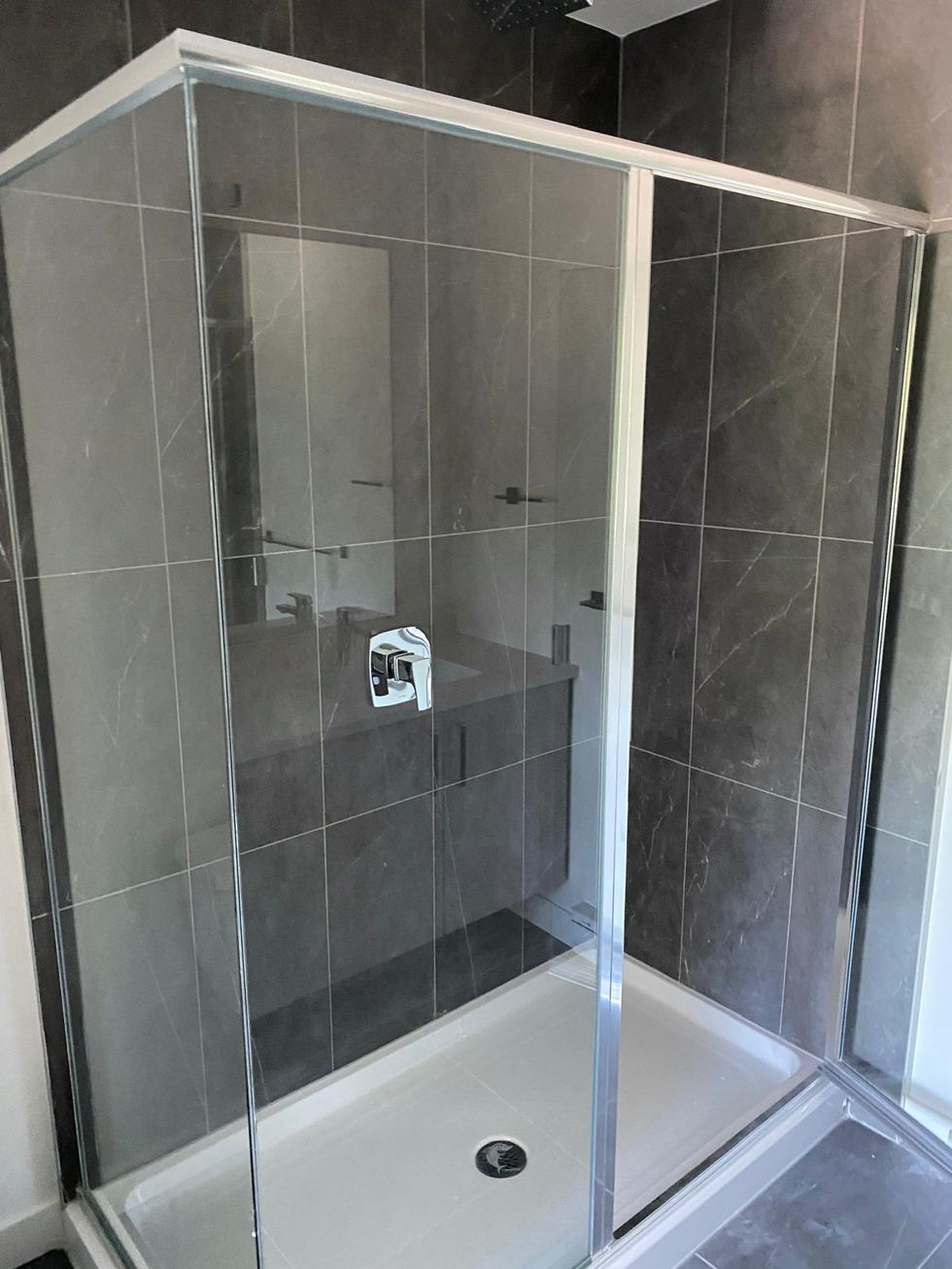 Modern frameless shower with gray tile