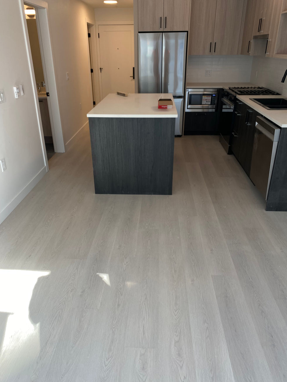 Modern kitchen with light gray vinyl plank flooring