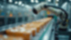 Close-up of robotic arm sorting packaged food items on conveyor belt