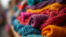 Vibrant handcrafted textiles displayed in a market in Africa.