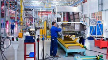 Eye-level view of a large industrial manufacturing plant with machinery and assembly lines