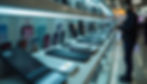 High angle view of a busy electronics store shelf filled with various smartphone models
