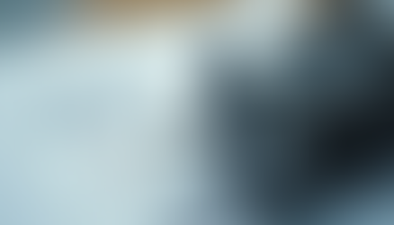 Close-up of a metal motor resting on technical drawings with colored wiring diagrams