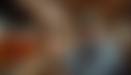 Farmer examining jars of homemade preserves in rustic storage