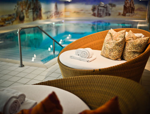 cozy chairs next to a swimming pool