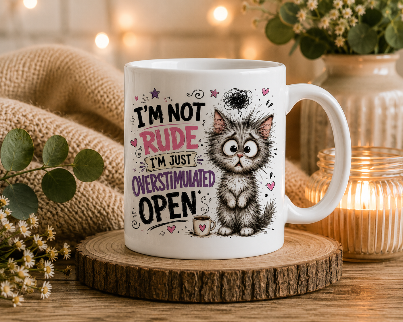 Funny ceramic mug featuring a fluffy grey cat with the quote "I'm Not Rude, I'm Just Overstimulated."