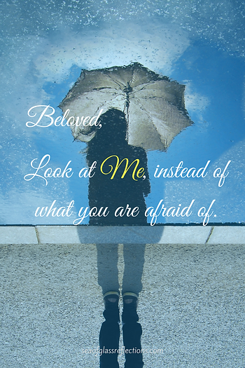 reflection in water of a woman holding an umbrella. Look at Me instead of what you are afraid of.
