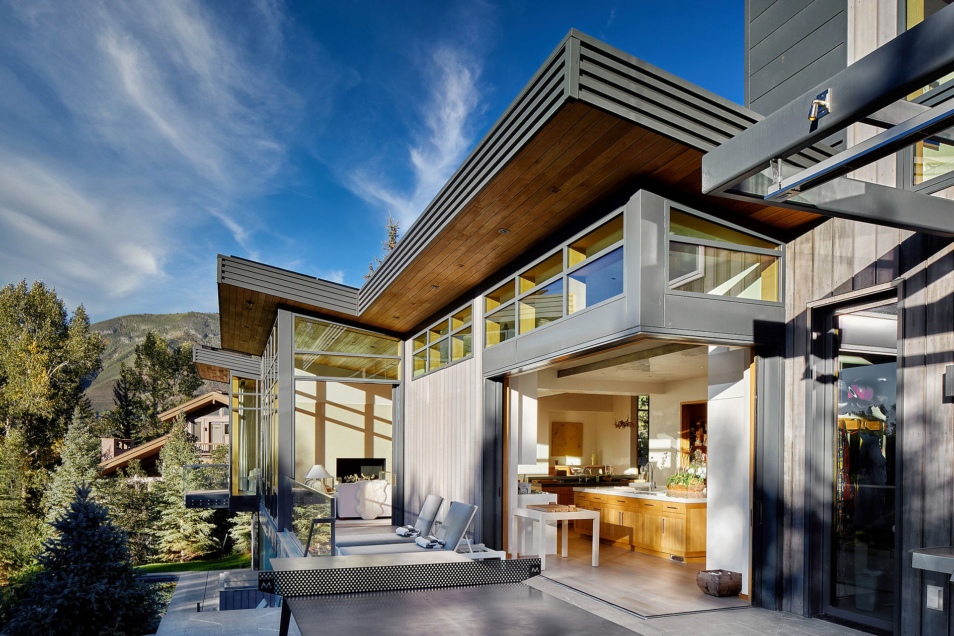 Shadow Mountain Residence indoor outdoor living between kitchen, living room, and outdoor upper patio area