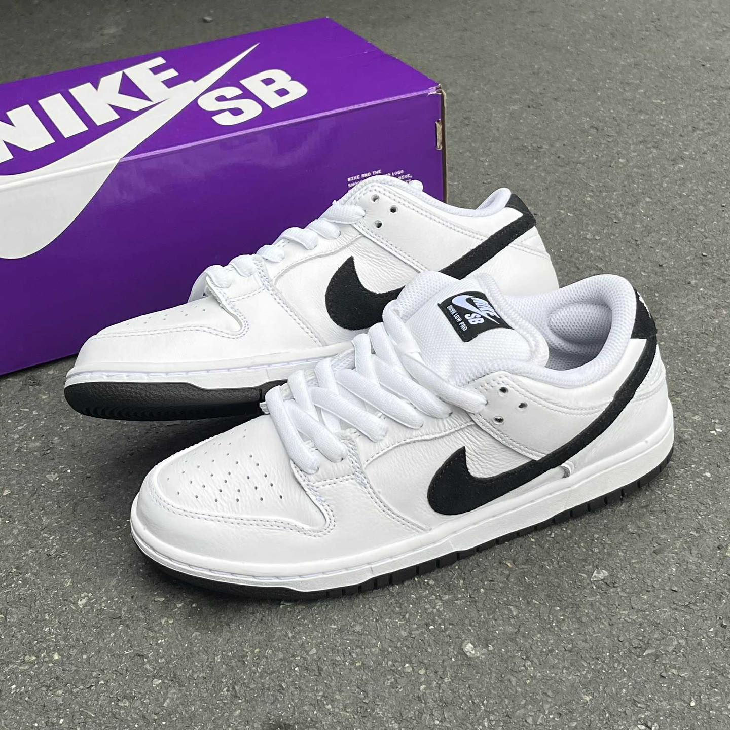 Nike SB Dunk Low white and black sneakers for men with premium leather design and black swoosh