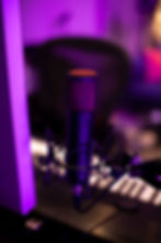 Eye-level view of a compact recording studio with microphone and mixing console