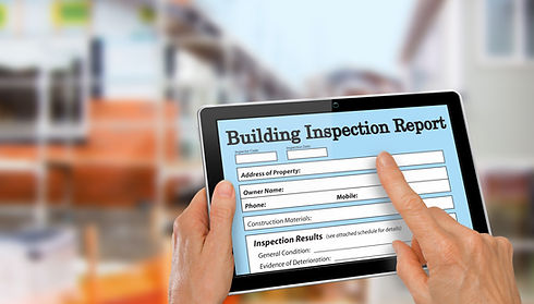 Building Inspector completing an inspection form on computer tablet.jpg