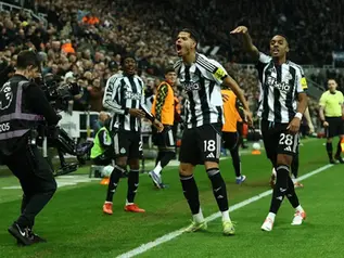 Newcastle United players celebrate late goal against Manchester United