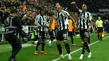 Newcastle United players celebrate late goal against Manchester United