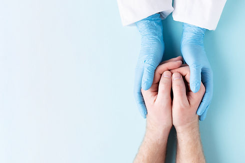 doctors-hands-holding-mans-hands-8UXPKYT
