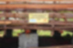 Wooden hay store at farm in Kenya with a sign stating support from Animal Kind International.