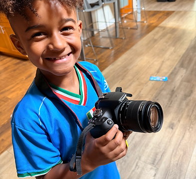 boy holding camera in film class