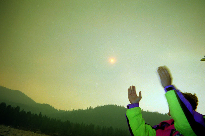 Wake Surfing in Lake Tahoe, California, smoke in the sky