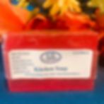 A pink bar of soap with a white label on it that say Kitchen Soap and the Casaroma Label