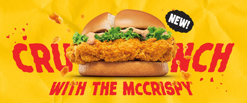 Crispy chicken sandwich with lettuce on yellow background. Red text reads "CRUNCH WITH THE McCRISPY." Black label says "NEW!"