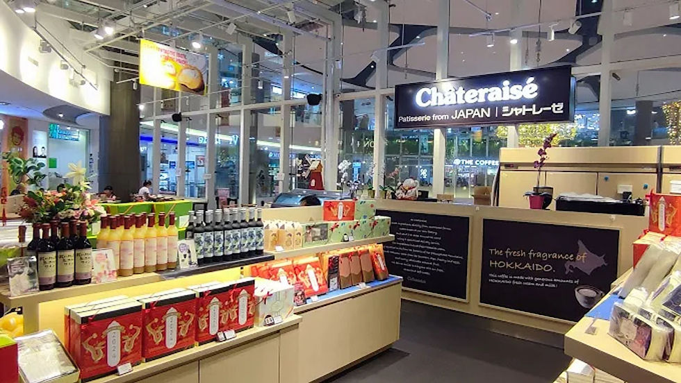 Japanese patisserie store "Châteraisé" with colorful displays of wine, snacks, and flowers. Bright interior with large windows.